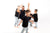 Happy family in matching black tees and denim jeans enjoying playful moments modern fashion for all ages.