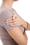 Golden Claudia Shine Ring worn on a woman's hand, paired with a neutral outfit and white nails, exuding effortless sophistication.