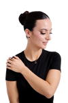 Graceful woman wearing a sleek black outfit, showcasing gold stud earrings, a minimalist necklace, and a stylish gold ring.