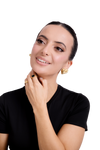 Smiling woman wearing statement gold earrings and matching rings, styled with a sleek black top – elegant jewelry fashion