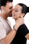 Romantic couple sharing an intimate moment, showcasing gold statement earrings and a sleek men's bracelet for a modern style.