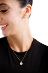 Sophisticated Etoile Stud earrings, showcasing a white centerpiece framed in gold, ideal for formal or casual wear.