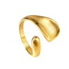 Elisa Ring is a contemporary gold band with an artistic teardrop detail offering a perfect blend of elegance and modern aesthetics.