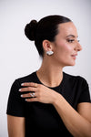 Elegant Woman Wearing Silver Earrings and Stylish Rings – Modern Jewelry Collection by Casa Di Milan