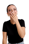 Elisa Ring in gold displayed on a laughing woman’s hand, adding a touch of glamour to her casual black top and denim look.